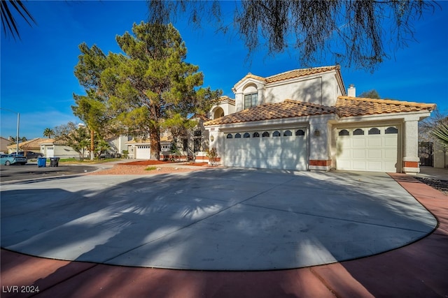 mediterranean / spanish house with a garage