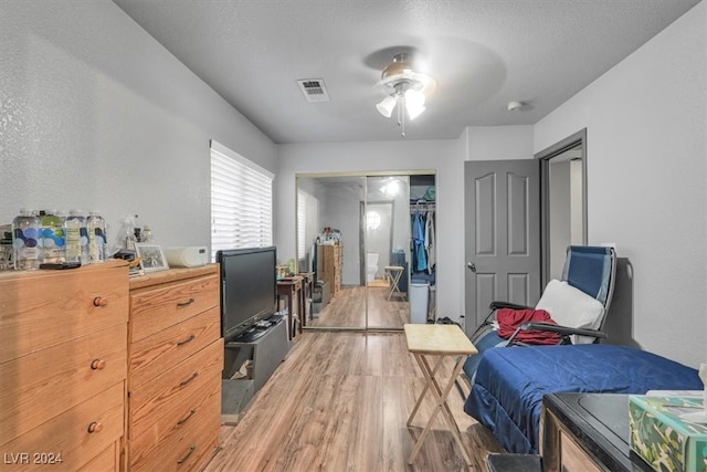 bedroom with a closet, ceiling fan, and hardwood / wood-style floors