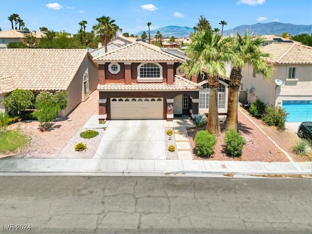 view of front of property with a mountain view and a garage