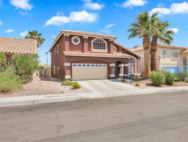 mediterranean / spanish-style house with a garage