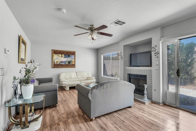 living room with plenty of natural light, hardwood / wood-style flooring, and ceiling fan