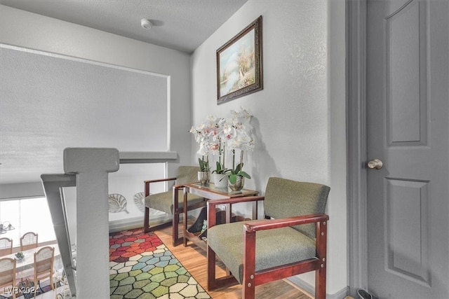 sitting room with light hardwood / wood-style flooring