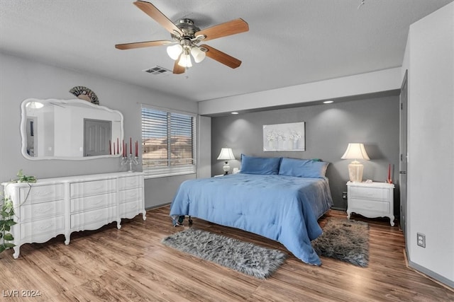 bedroom with wood-type flooring and ceiling fan