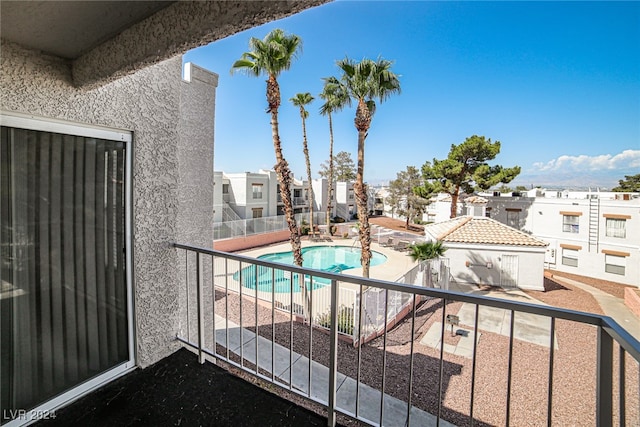 balcony featuring a fenced in pool and a patio area