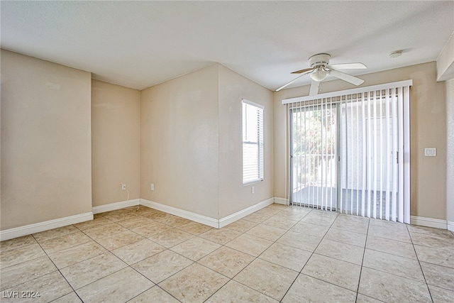 tiled empty room with ceiling fan