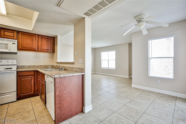 kitchen featuring white appliances, light tile patterned floors, light stone countertops, and ceiling fan