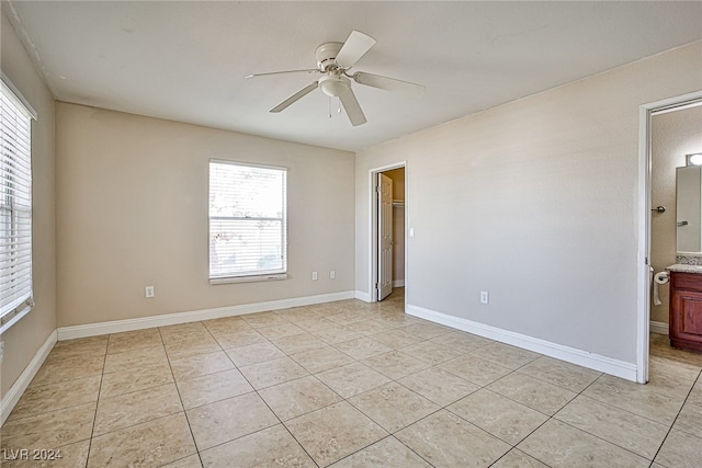 tiled empty room with ceiling fan