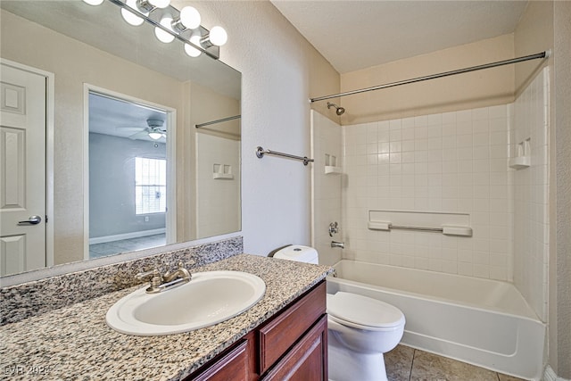 full bathroom with toilet, tile patterned flooring, vanity, tiled shower / bath combo, and ceiling fan