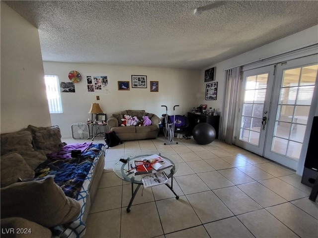 living area with light tile patterned flooring, french doors, and a textured ceiling