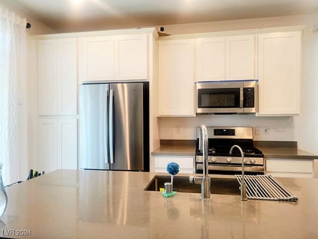 kitchen featuring appliances with stainless steel finishes and white cabinetry