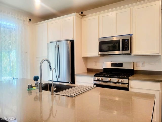 kitchen with appliances with stainless steel finishes and white cabinets