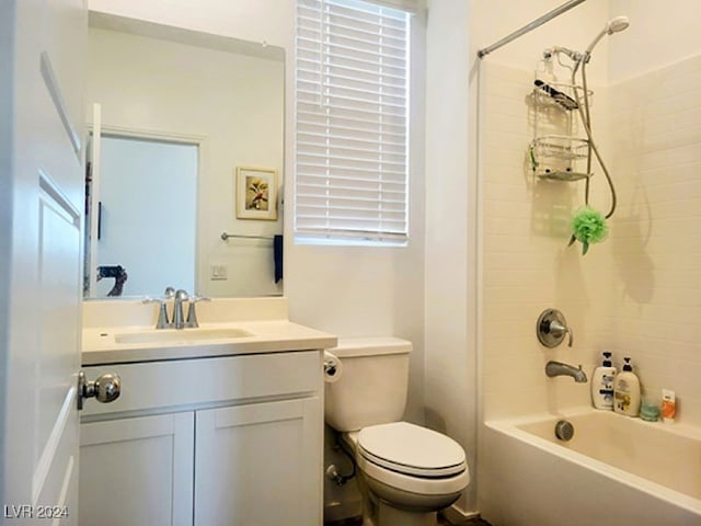 full bathroom featuring tiled shower / bath, vanity, and toilet