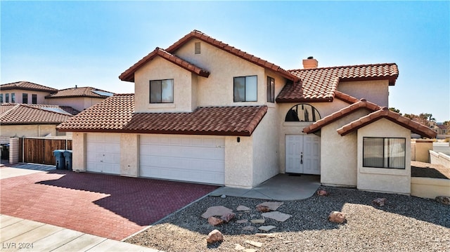 mediterranean / spanish-style home featuring a garage