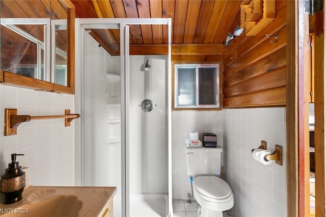 bathroom with toilet, walk in shower, tile patterned flooring, vanity, and tile walls