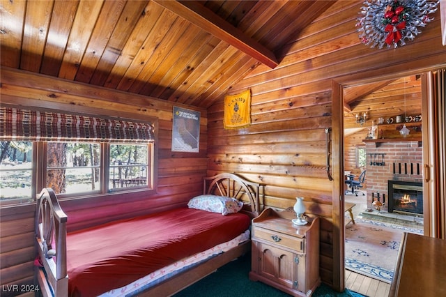 bedroom with lofted ceiling with beams, a brick fireplace, wood ceiling, and dark hardwood / wood-style floors