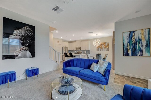 living room featuring light colored carpet and a chandelier