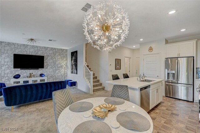 carpeted dining room with a notable chandelier and sink