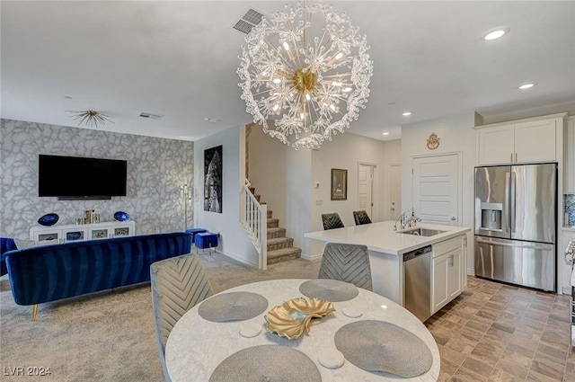 dining area featuring sink and a notable chandelier