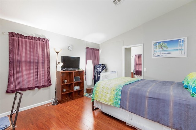 bedroom with lofted ceiling and hardwood / wood-style flooring