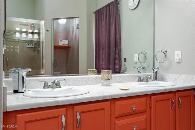 bathroom with a shower with door and vanity