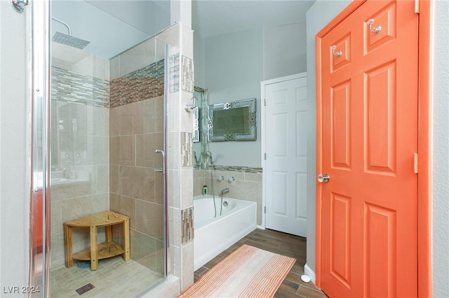 bathroom with hardwood / wood-style flooring and separate shower and tub