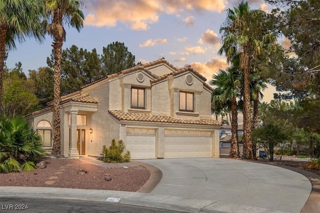 mediterranean / spanish-style home featuring a garage