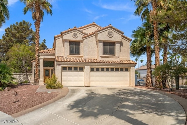 mediterranean / spanish house with a garage