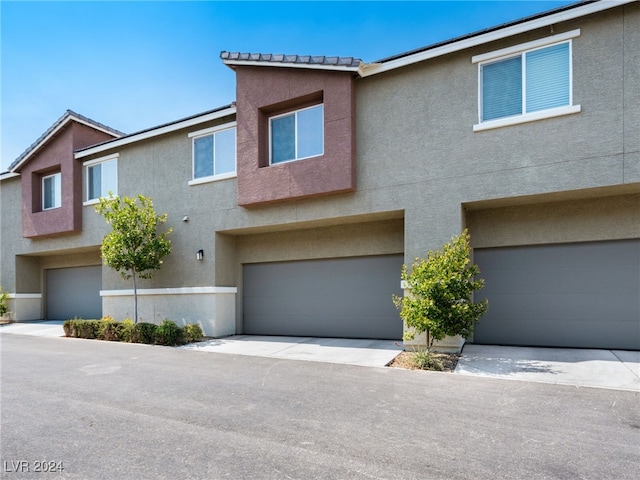 multi unit property featuring a garage