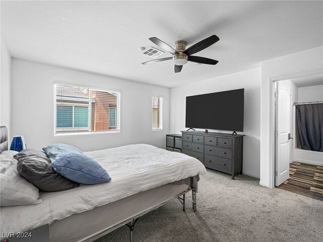 carpeted bedroom with a walk in closet, ceiling fan, and a closet