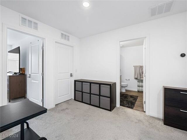 carpeted bedroom featuring ensuite bathroom