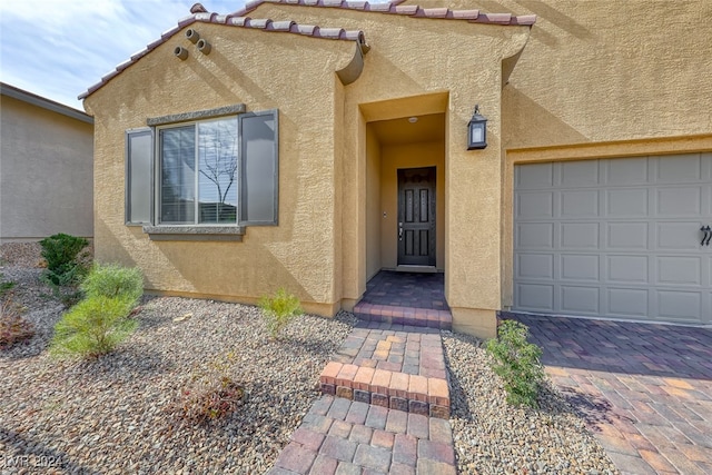 doorway to property featuring a garage