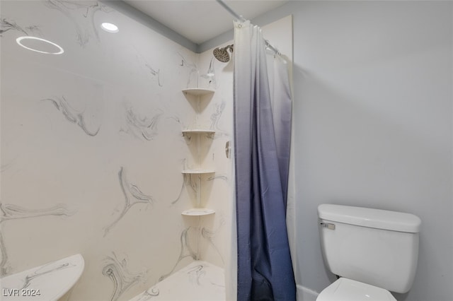 bathroom with toilet and a shower with shower curtain