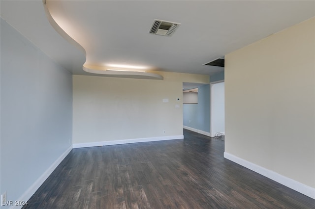 empty room with dark wood-type flooring