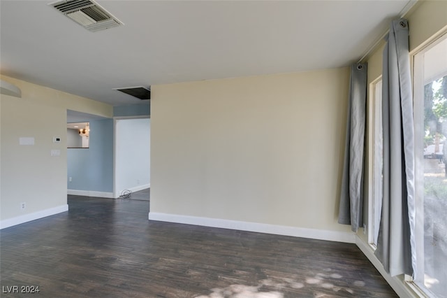 spare room featuring dark wood-type flooring