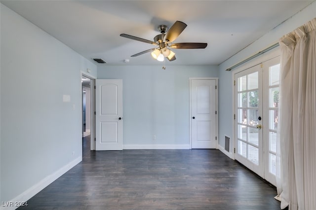 spare room with dark wood-type flooring, ceiling fan, and french doors