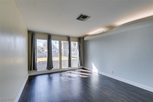 unfurnished room featuring dark hardwood / wood-style flooring