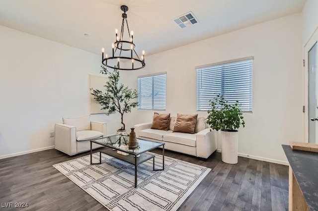 living room with visible vents, baseboards, an inviting chandelier, and dark wood-style floors