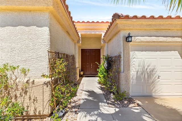 view of exterior entry with a garage