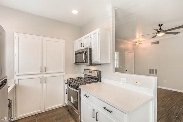 kitchen with ornamental molding, stainless steel appliances, ceiling fan, dark hardwood / wood-style floors, and white cabinets