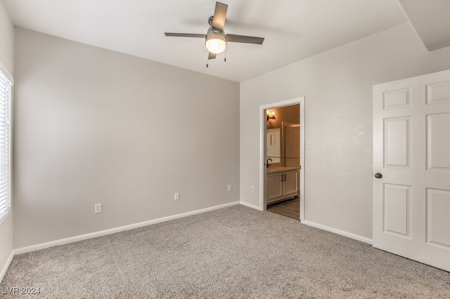 unfurnished bedroom with connected bathroom, ceiling fan, and carpet flooring