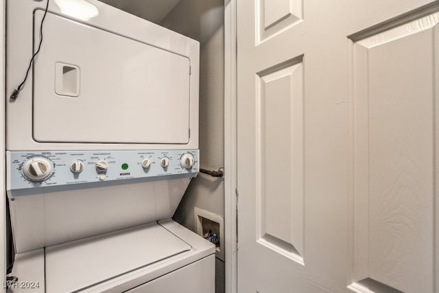 laundry area with stacked washer / drying machine