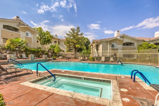 view of pool featuring a community hot tub and a patio