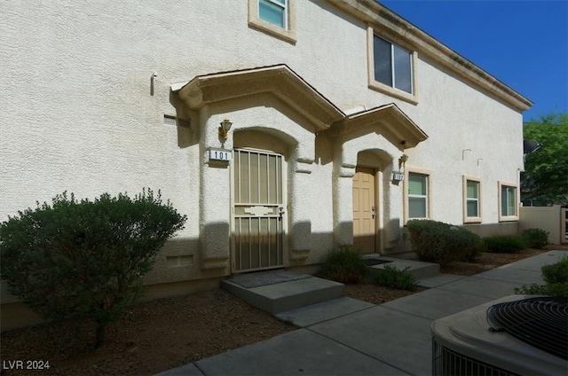 doorway to property featuring central AC unit