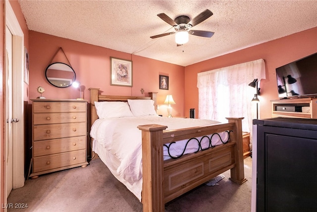 bedroom featuring a textured ceiling, ceiling fan, and carpet