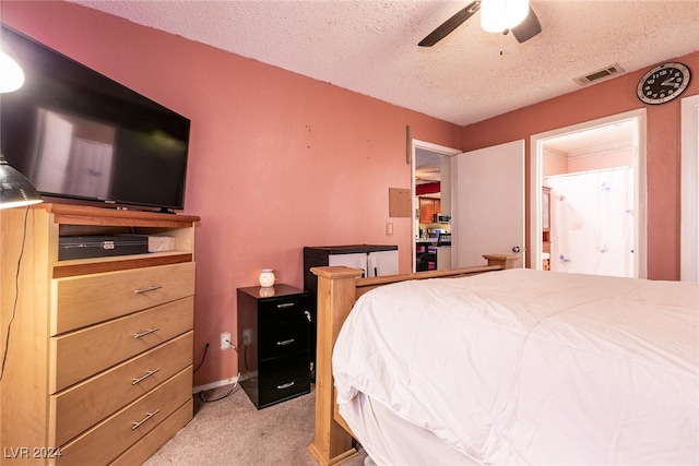 carpeted bedroom featuring a textured ceiling and ceiling fan