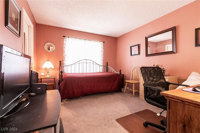 carpeted bedroom with a textured ceiling