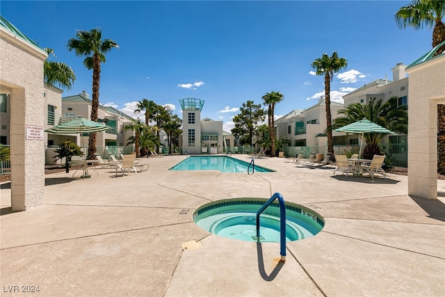 view of pool with a community hot tub and a patio