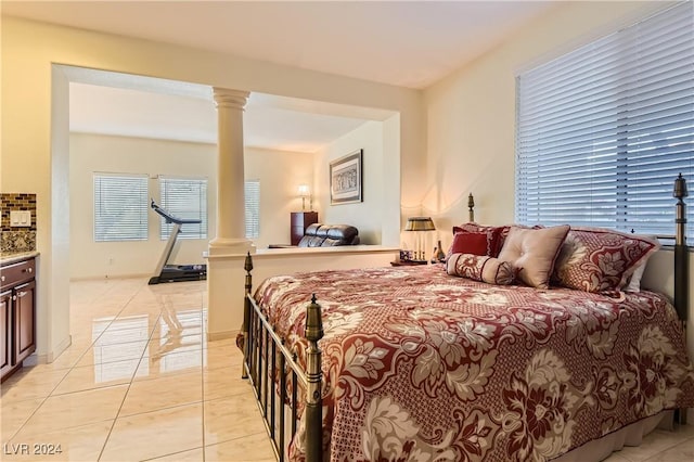 tiled bedroom featuring ornate columns