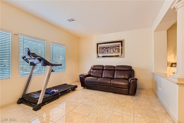 exercise room with light tile patterned flooring