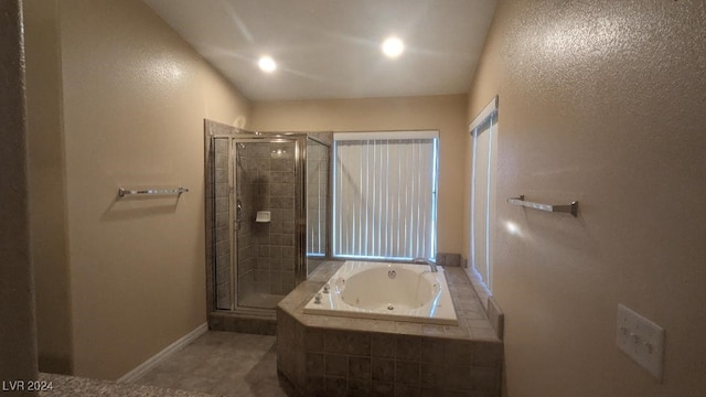 bathroom with independent shower and bath and tile patterned flooring